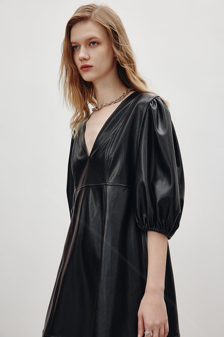 MADEINAM Ballon Sleeve Leather Dress. Faux Leather. Black. Ganni Sytle. Soft faux leather Mini length A-line silhouette V-neck Elasticated elbow length ballon sleeves. Available in size XS, S, M, L