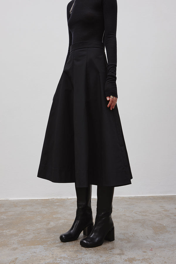 MADEINAM A Line Skirt. Black A-line silhouette. Above ankle. Concealed side zip closure. Match up fit knit top. Top up with a long MADEINAM trench coat. Available in size XS, S, M,  L.